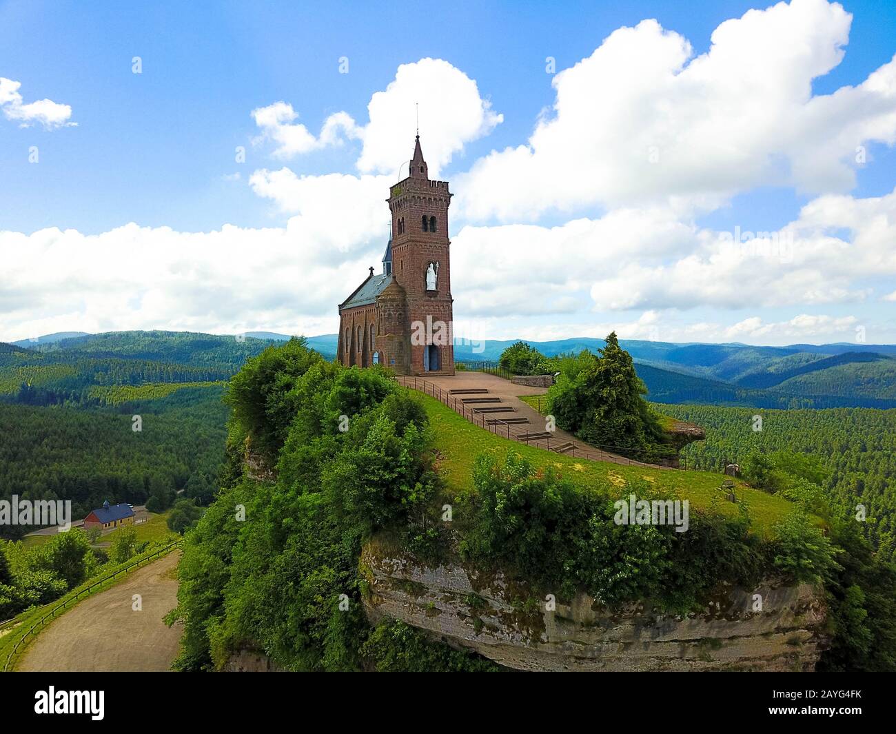 Beautiful autumn aerial view of St. Leon chapel dedicated to Pope Leo IX atop of Rocher de Dabo (Rock of Dabo), red sandstone rock butte Stock Photo