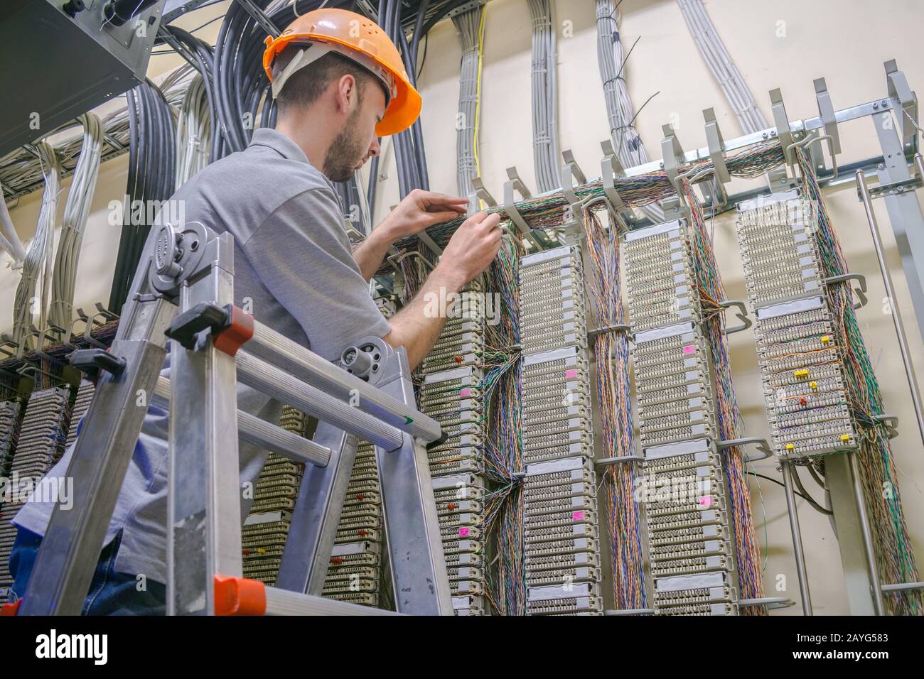 The engineer works in the server room of the data center. Cable laying