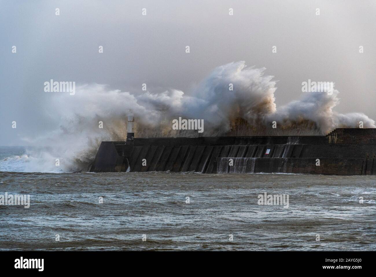 Large Storm Waves breaking over Porthcawl Pier during Storm Ciara Stock Photo