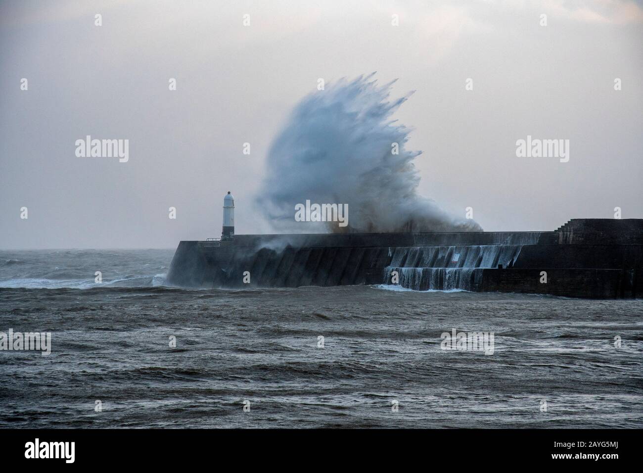 Large Storm Waves breaking over Porthcawl Pier during Storm Ciara Stock Photo