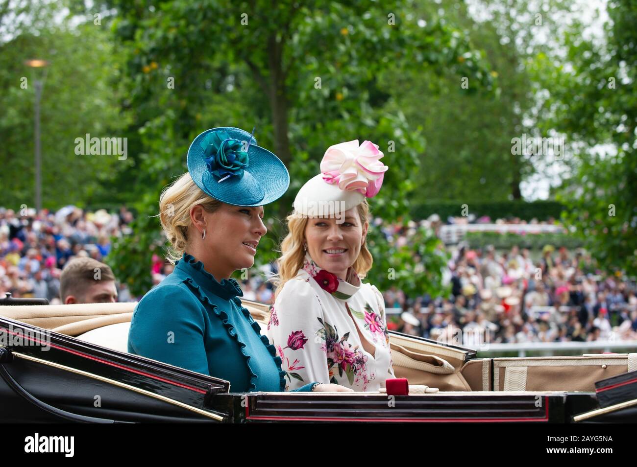 Royal Ascot Ladies Day, Ascot Racecourse, UK. 20th June, 2019. Zara Tindall and Autumn Phillips arrive in a horse drawn carriage in the Royal Procession at Royal Ascot. Credit: Maureen McLean/Alamy Stock Photo
