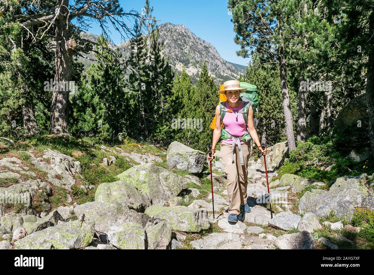 women hiker with backpack on mountain trail in the Pyrenees mountains Stock Photo