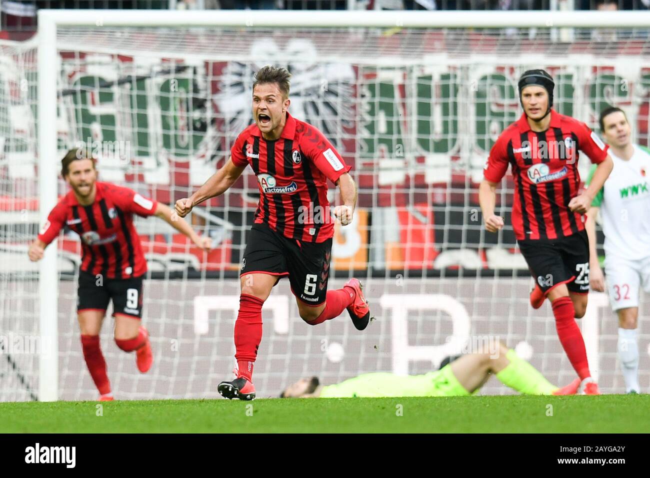 Duesseldorf, Germany. Paderborn, Deutschland. 15th Feb, 2020. Augsburg, Germany. 15th Feb, 2020. Football: Bundesliga, 22nd matchday, FC Augsburg - SC Freiburg, WWK Arena. Freiburg's Lucas Höler (l-r), Amir Abrashi and Robin Koch cheer after Haberer's goal for 1:1. Credit: Tom Weller/dpa - IMPORTANT NOTE: In accordance with the regulations of the DFL Deutsche Fußball Liga and the DFB Deutscher Fußball-Bund, it is prohibited to exploit or have exploited in the stadium and/or from the game taken photographs in the form of sequence images and/or video-like photo series./dpa/Alamy Live News Credit Stock Photo