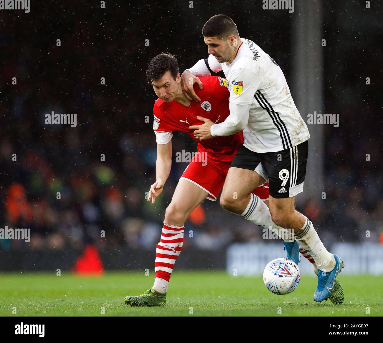 Craven Cottage, London, UK. 15th February 2020; Craven Cottage, London, England; English Championship Football, Fulham versus Barnsley; Aapo Halme of Barnsley challenges Aleksandar Mitrovic of Fulham Stock Photo