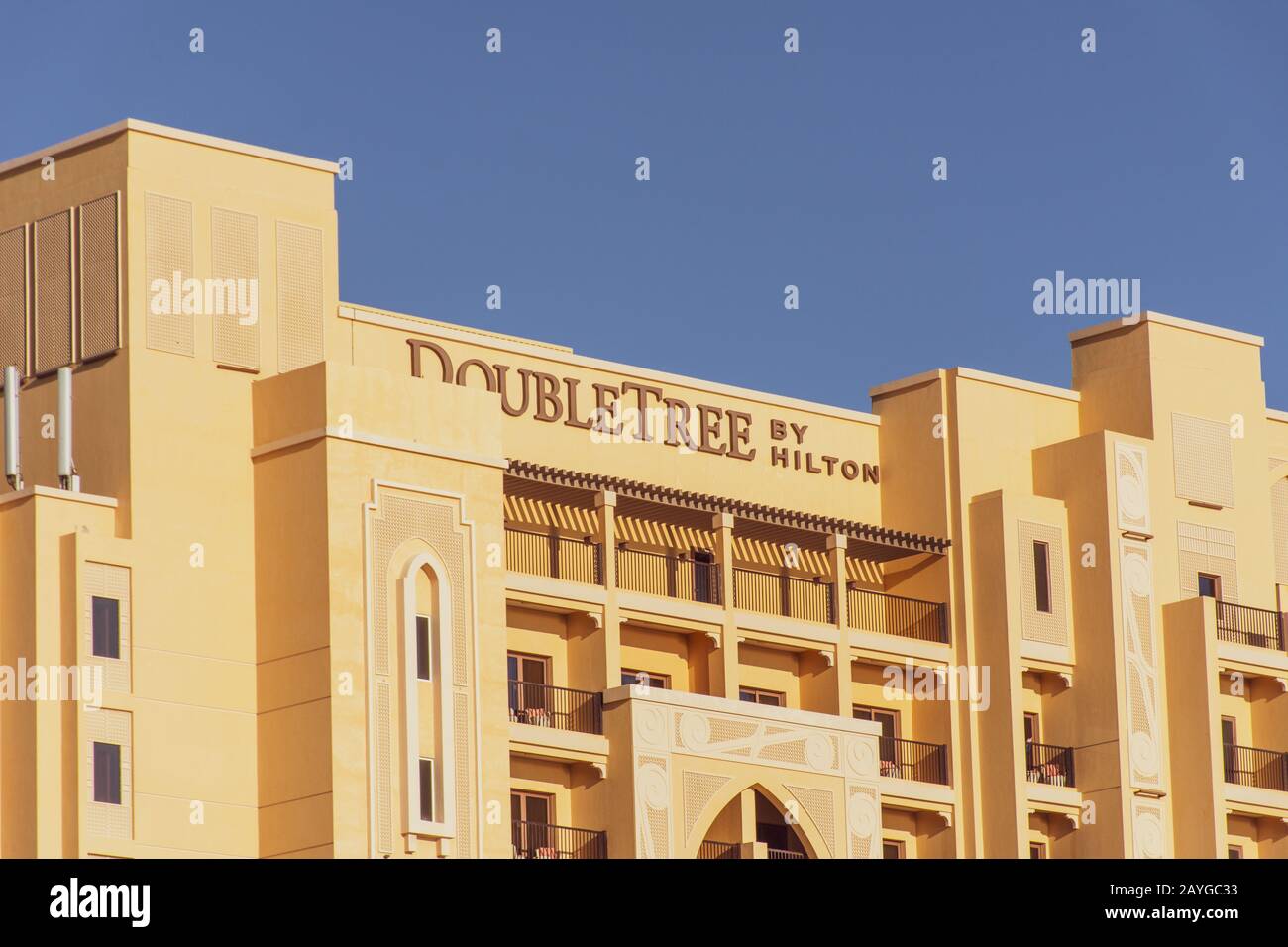 'Ras al Khaimah, Ras al Khaimah/United Arab Emirates - 2/14/2020: 'Hilton Double Tree Hotel close up of building sign against blue sky background Marj Stock Photo