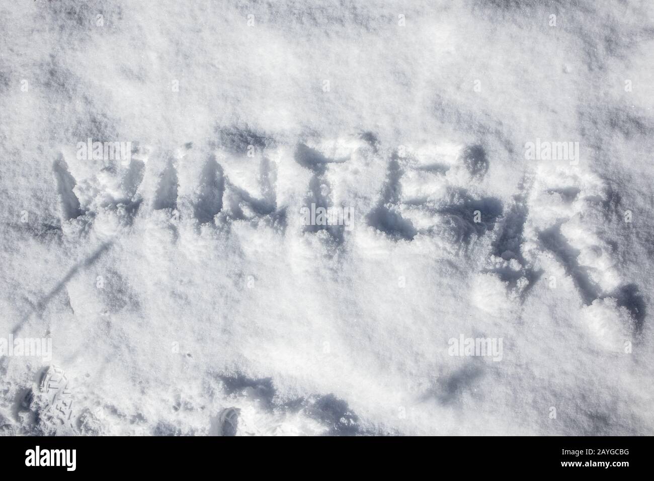 Snow winter text word on white sunny winter mood day. Light and bright snow holiday time Stock Photo