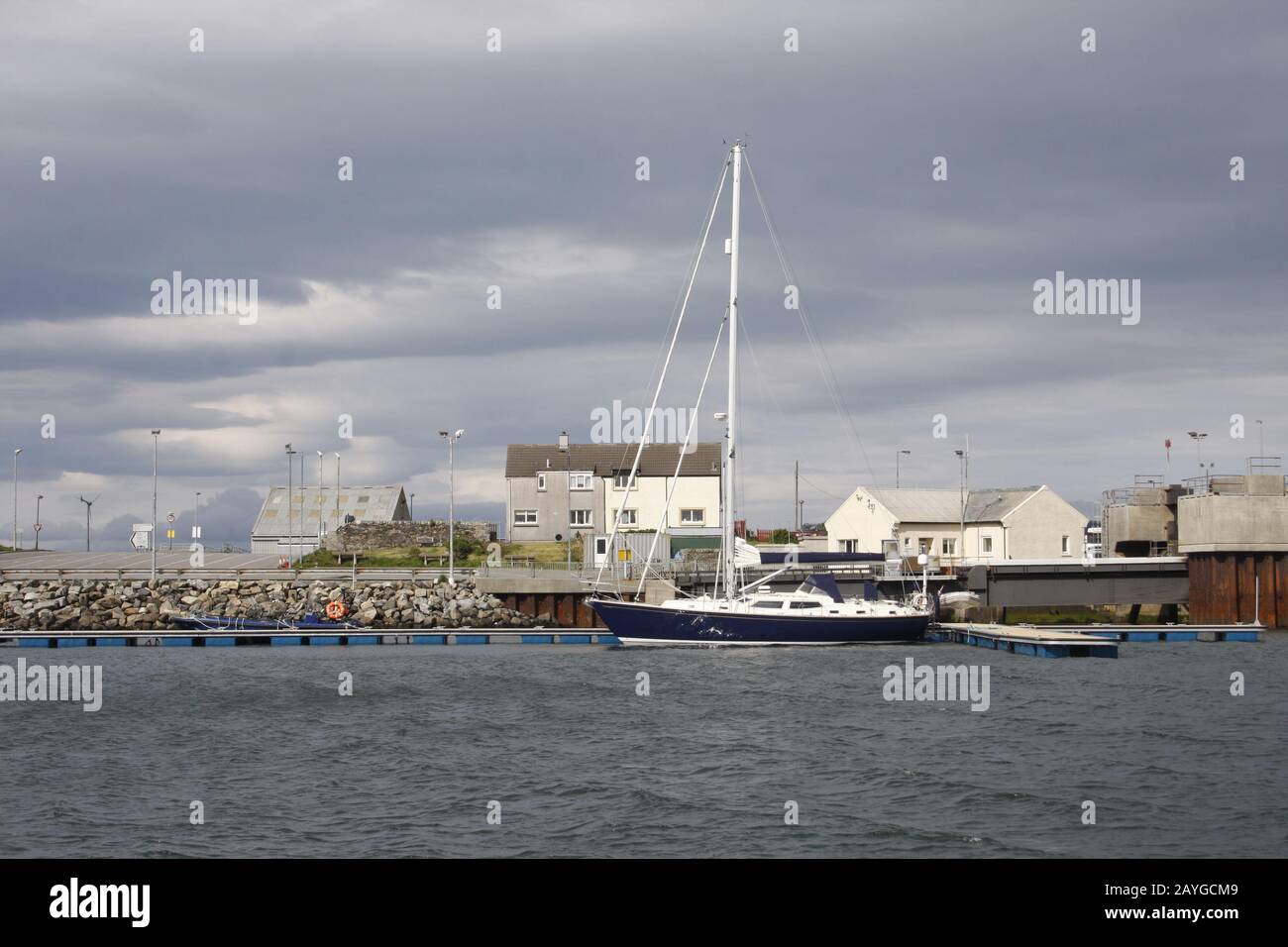 Sailing yacht alongside pontoon in new marina by the ferry terminal, Lochmaddy, North Uist, Western Isles, Scotland Stock Photo