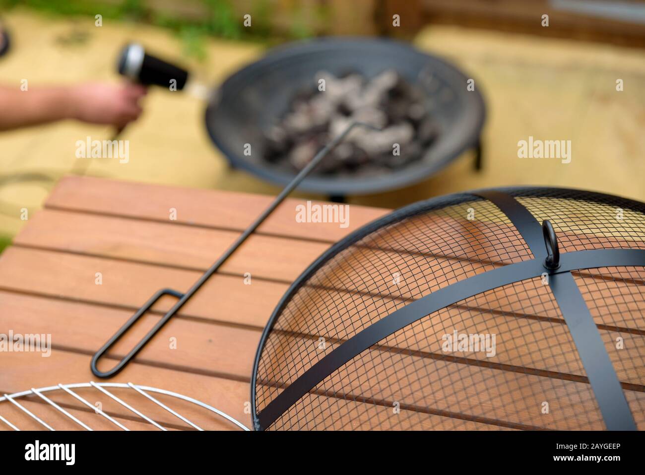 bbq grill charcoal starting fire with hair dryer in backyard in england