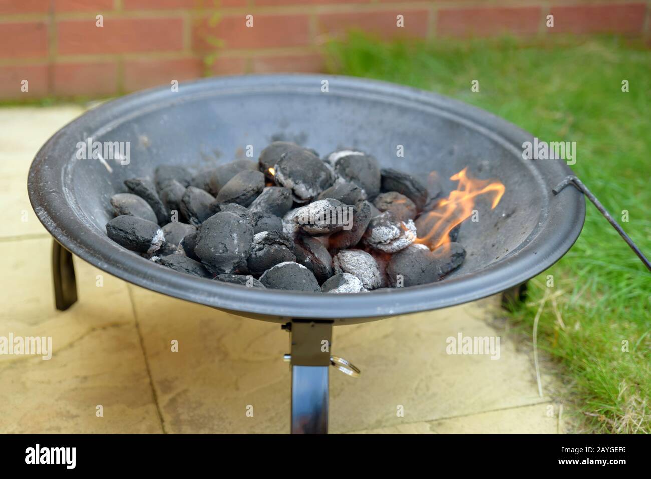 bbq grill charcoal starting fire for party in backyard in england uk