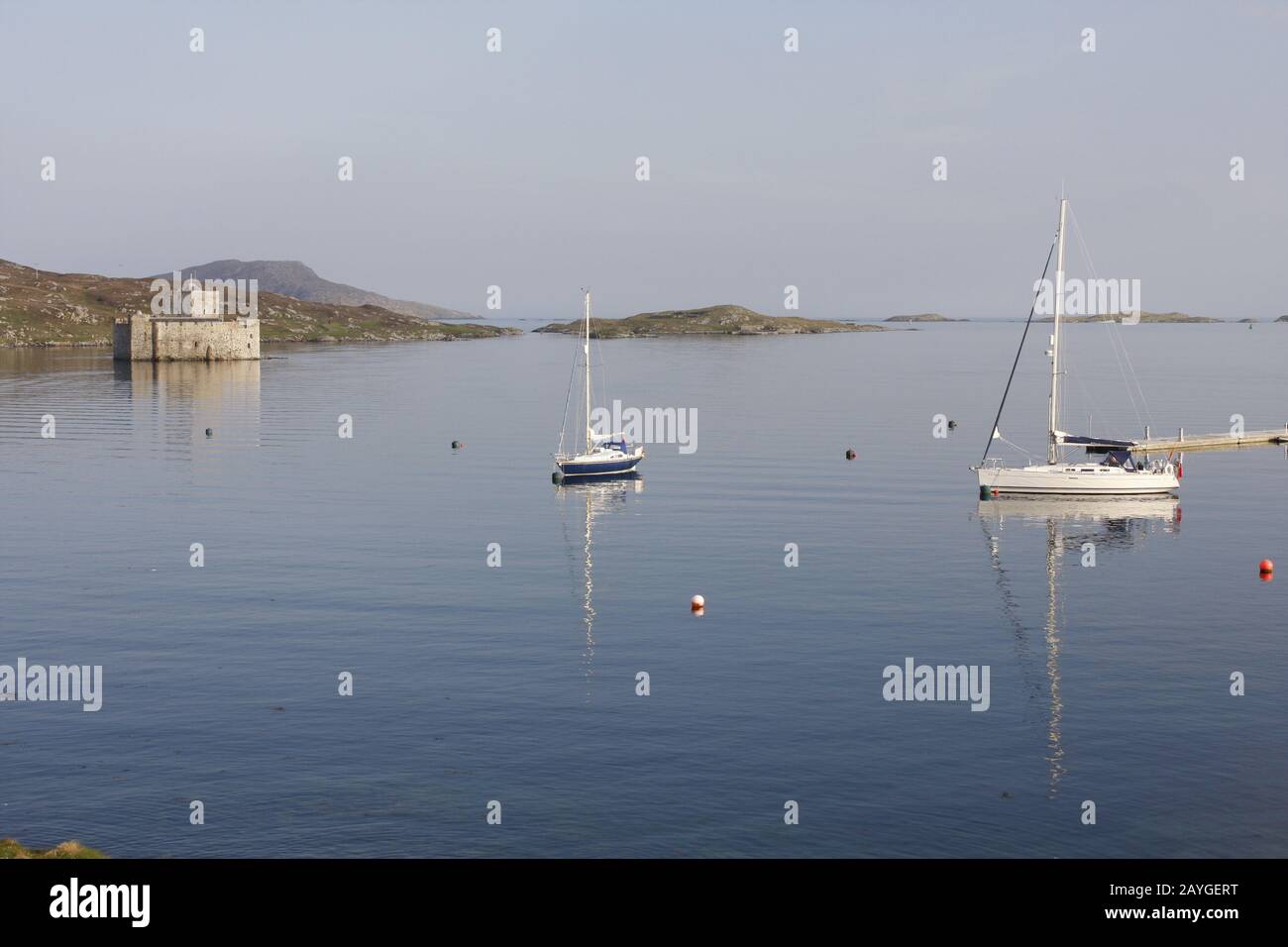 Kisimul Castle and yachts on moorings next to new marina, Castlebay, Isle of Barra, Western Isles, Scotland Stock Photo