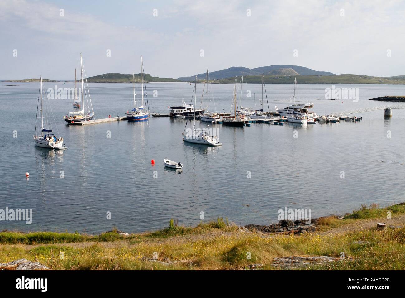 Yachts in the new marina and on the remaining 2 visitors' moorings in Castlebay, Barra, Western Isles Stock Photo