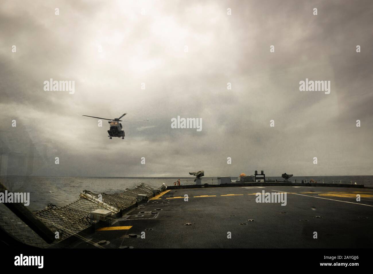 A Royal Canadian Air Force CH-148 Cyclone helicopter landing on the deck of a Canadian warship at sea seen from the Landing Safety Officer position. Stock Photo