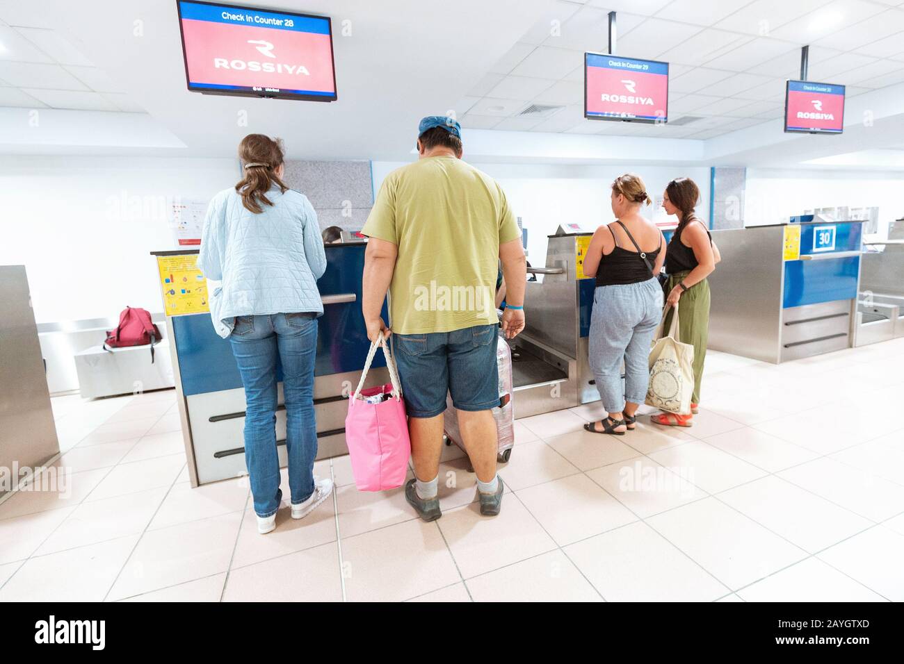 31 May 2019, Rhodes, Greece: Airport Check-In Desk with crowds of people in line Stock Photo