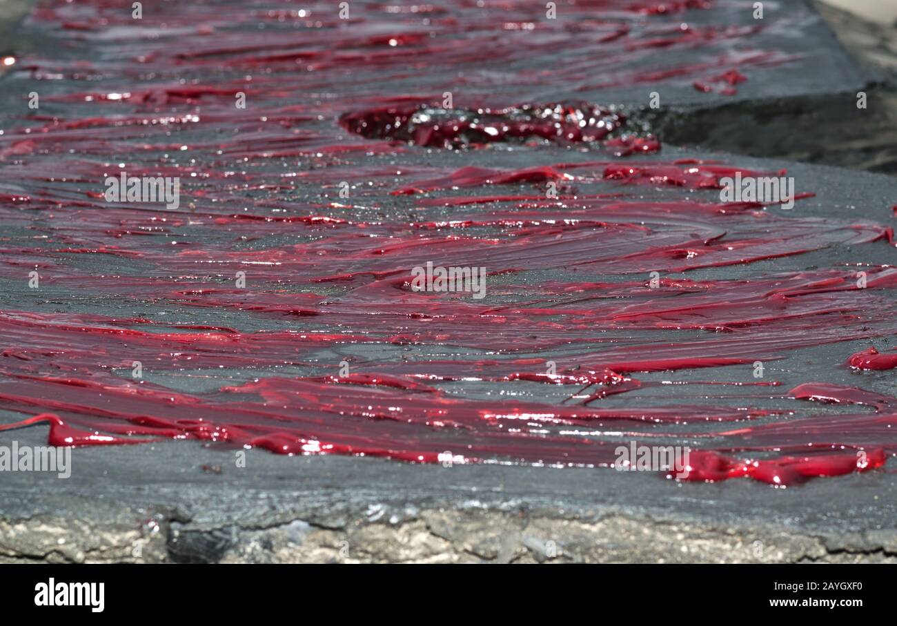 Fresh engine grease across a truck hitch plate to keep it lubricated during routine maintenance
