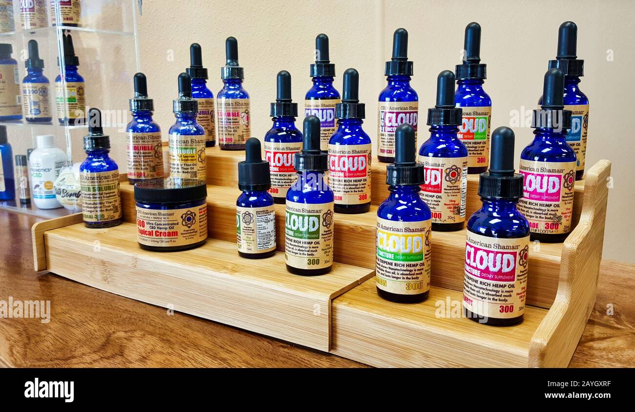 Hemp Oil bottles on wooden display in a CBD store in Houston, TX. This fast-growing industry has increased after the legalization of cannabis. Stock Photo