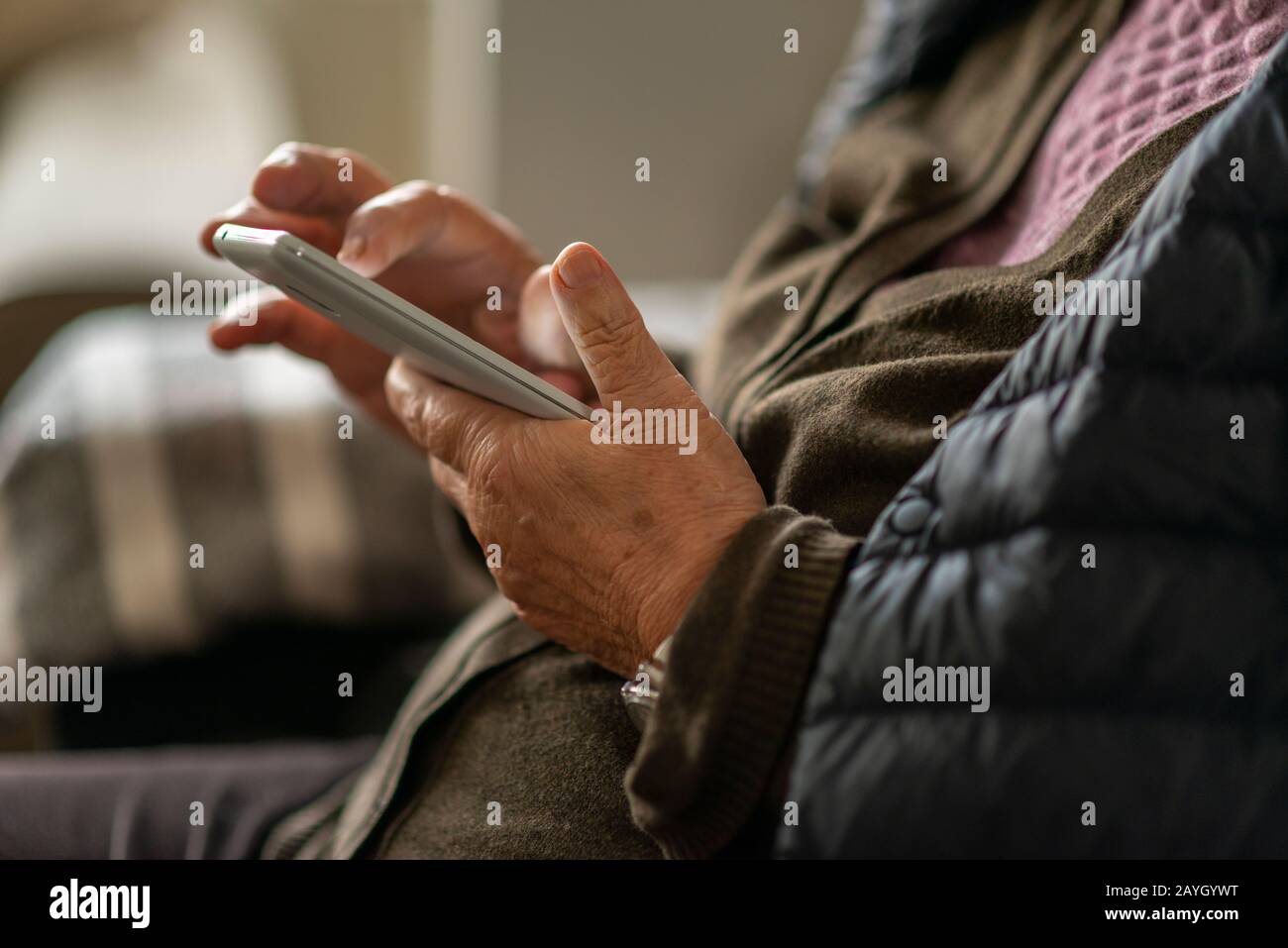 Hands Close-up of  older lady on reading on smart phone Stock Photo