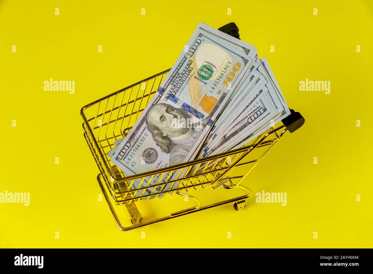 Grocery cart with currency US dollar cash on table banknotes close-up Stock Photo