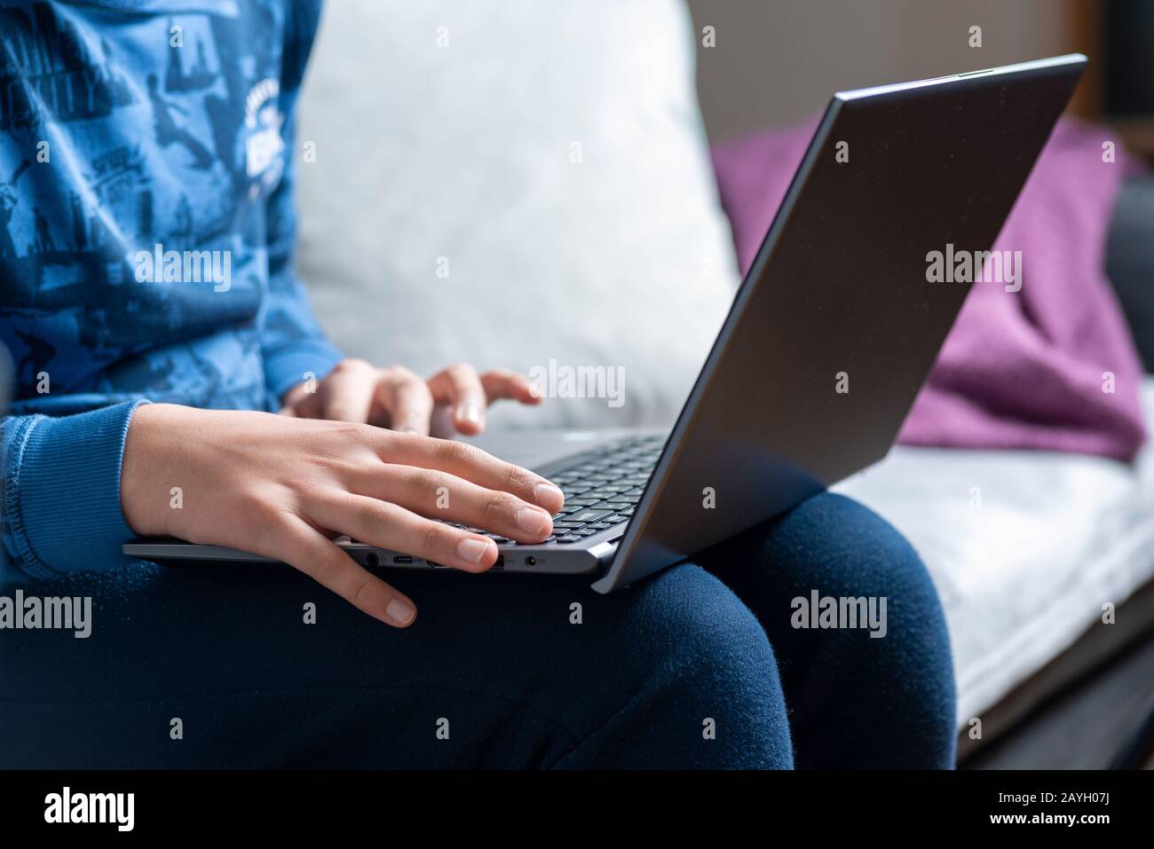 young boy watches videos online on laptop comuter Stock Photo