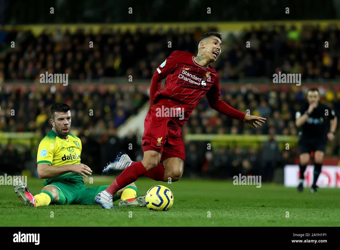 15th February 2020; Carrow Road, Norwich, Norfolk, England, English Premier League Football, Norwich versus Liverpool; Grant Hanley of Norwich City fouls Roberto Firmino of Liverpool Stock Photo