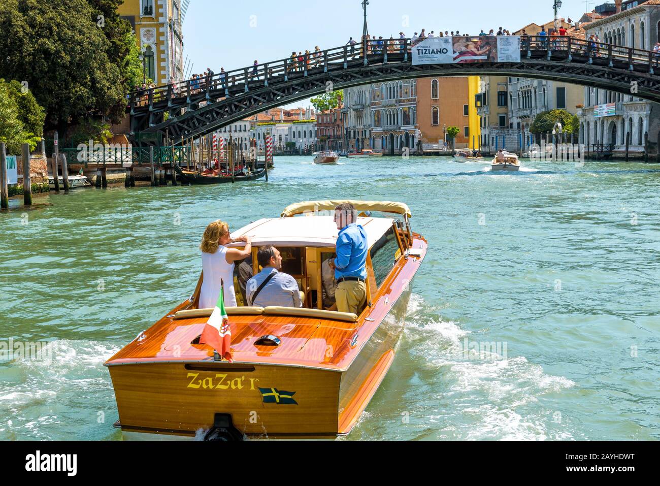 Venice, Italy - May 18, 2017: Water taxi with tourists sails along the Grand Canal in Venice. Motor boats are the main transport in Venice. Romantic w Stock Photo