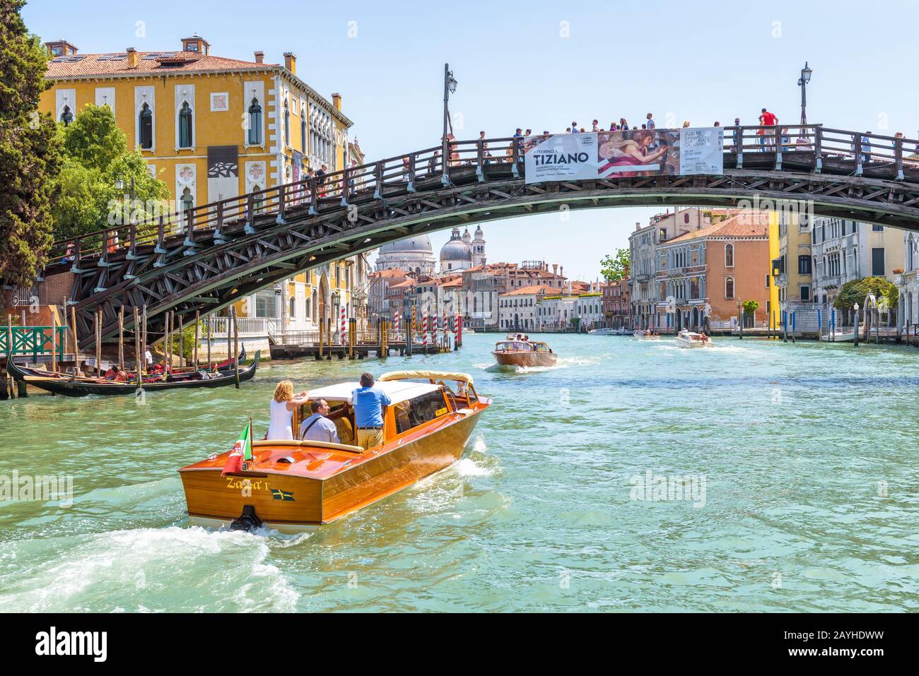 Venice, Italy - May 18, 2017: Water taxi with tourists sails on Grand Canal in Venice. Motor boats are the main transport in Venice. Romantic trip acr Stock Photo