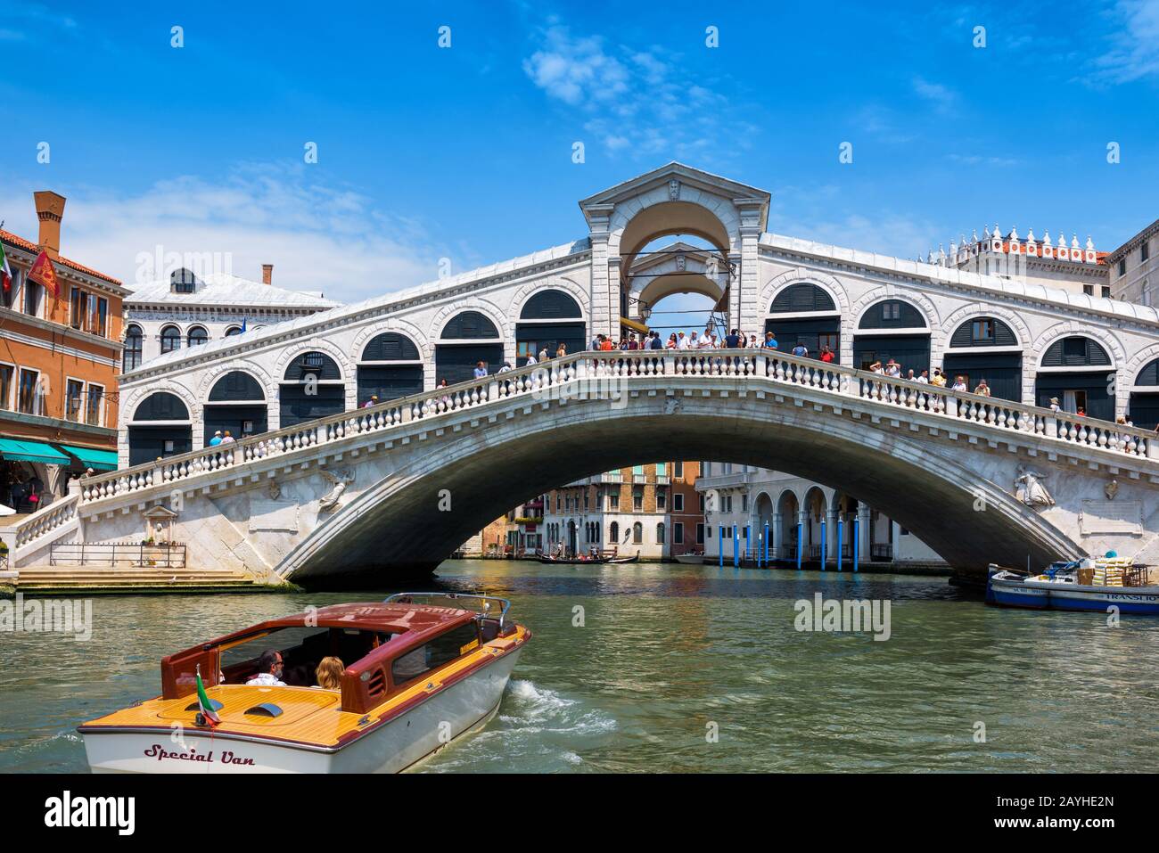 Venice, Italy - May 18, 2017: Water taxis are sailing along the Grand Canal to the Rialto Bridge. Rialto Bridge is one of the main tourist attractions Stock Photo