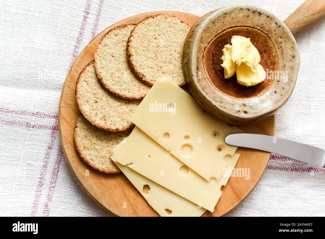 Cheese and biscuits snack of oat cakes with butter and emmental cheese