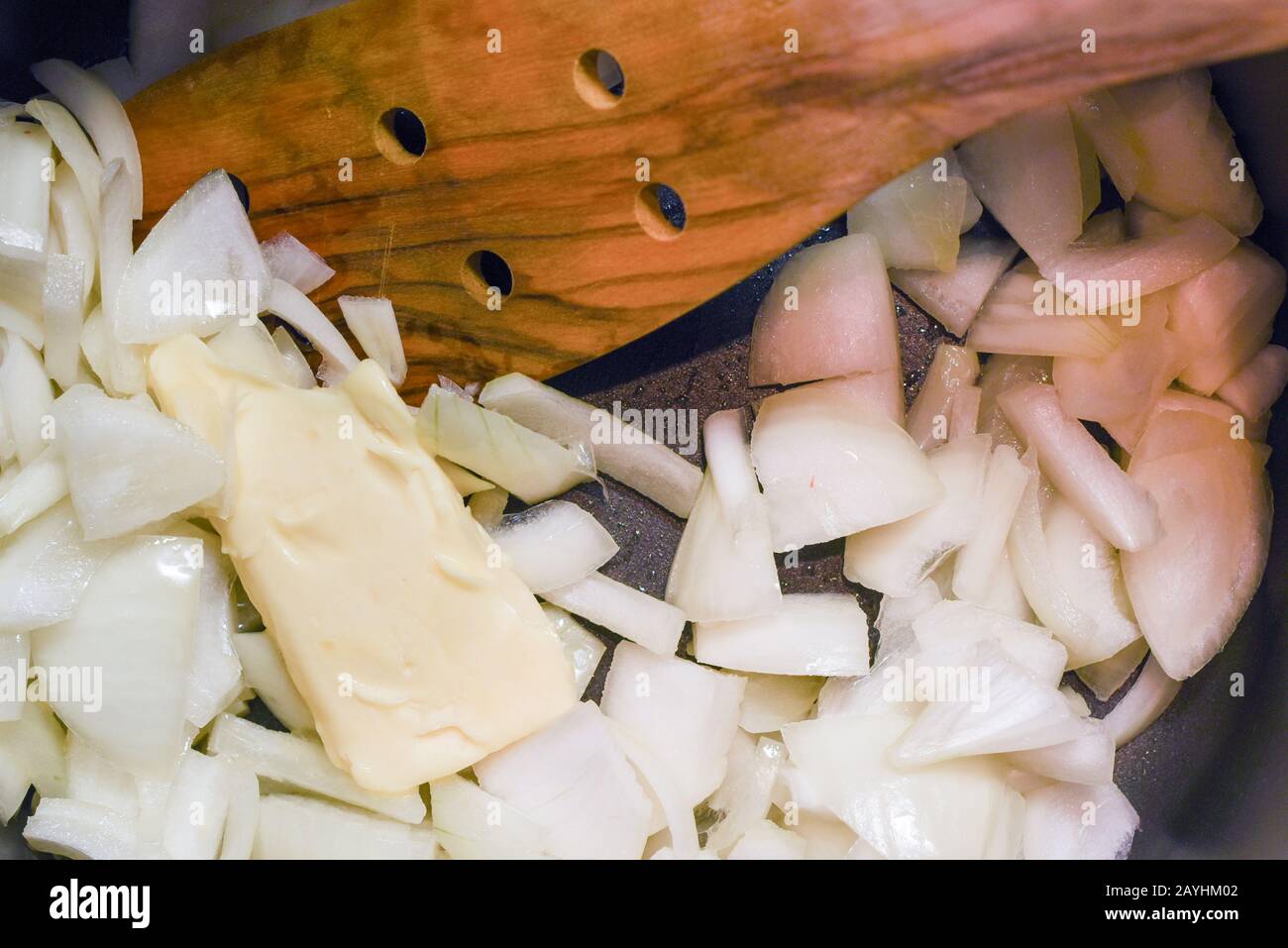 Cooking freshly chopped onion with butter to saute in a saucepan Stock