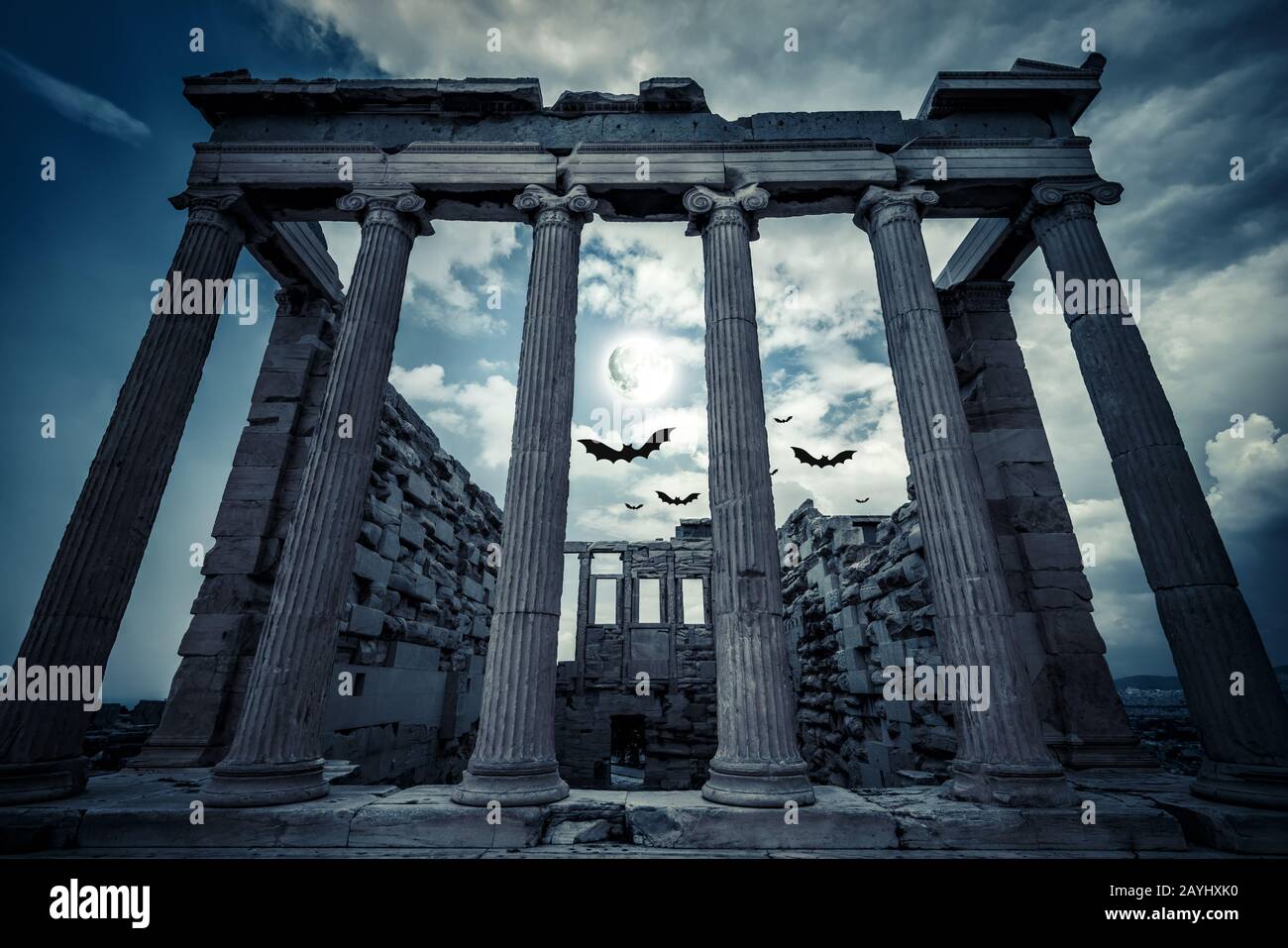 Erechtheion temple in full moon, Athens, Greece. Scary gloomy scene with bats for Halloween theme. Ancient Greek architecture of Athens at night. Old Stock Photo