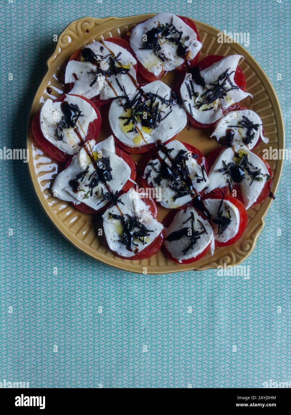 Sliced red tomatoes with mozzarella, olive oil, basil Stock Photo - Alamy