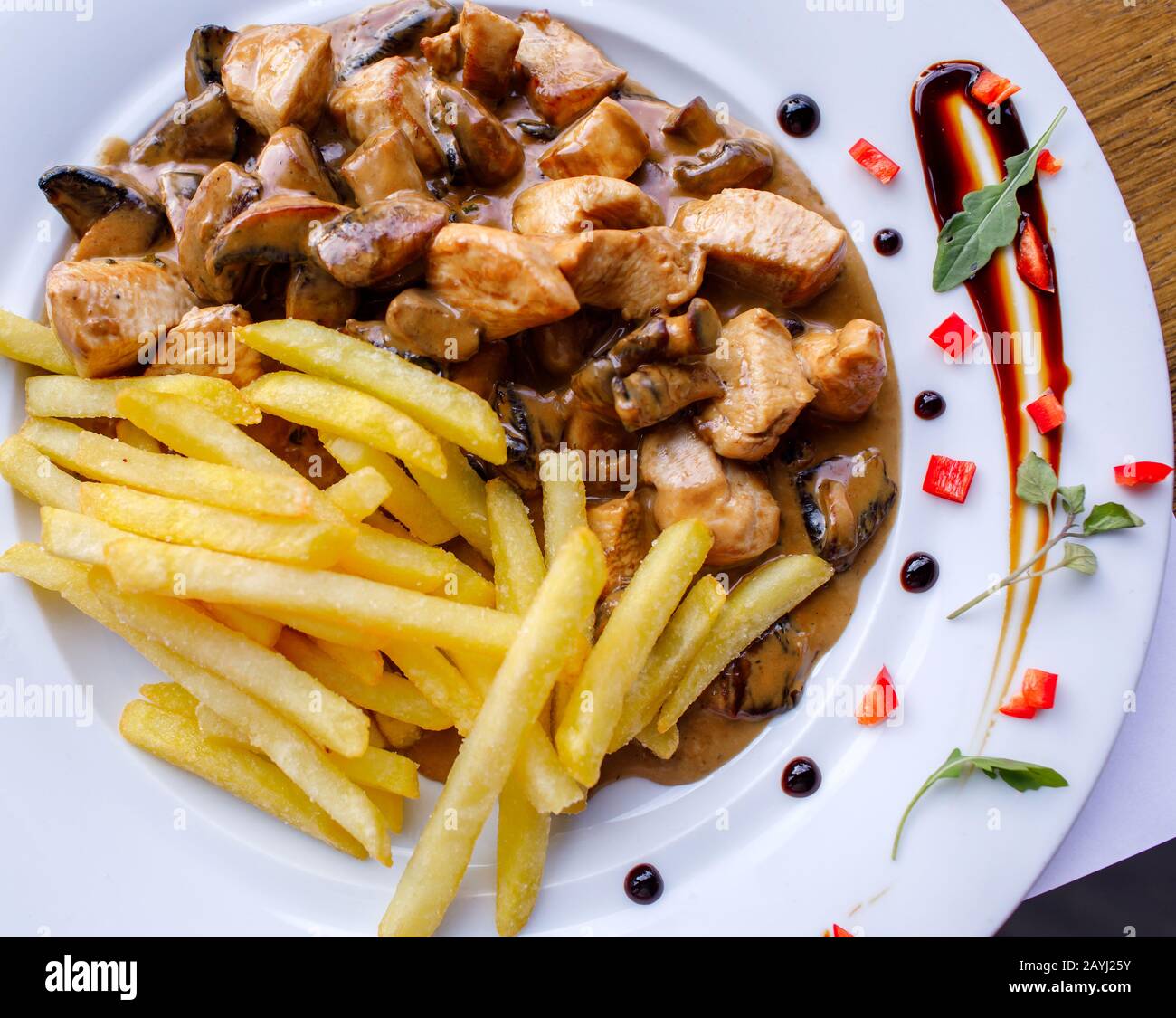 Meat and fries dish served in plate at restaurant Stock Photo