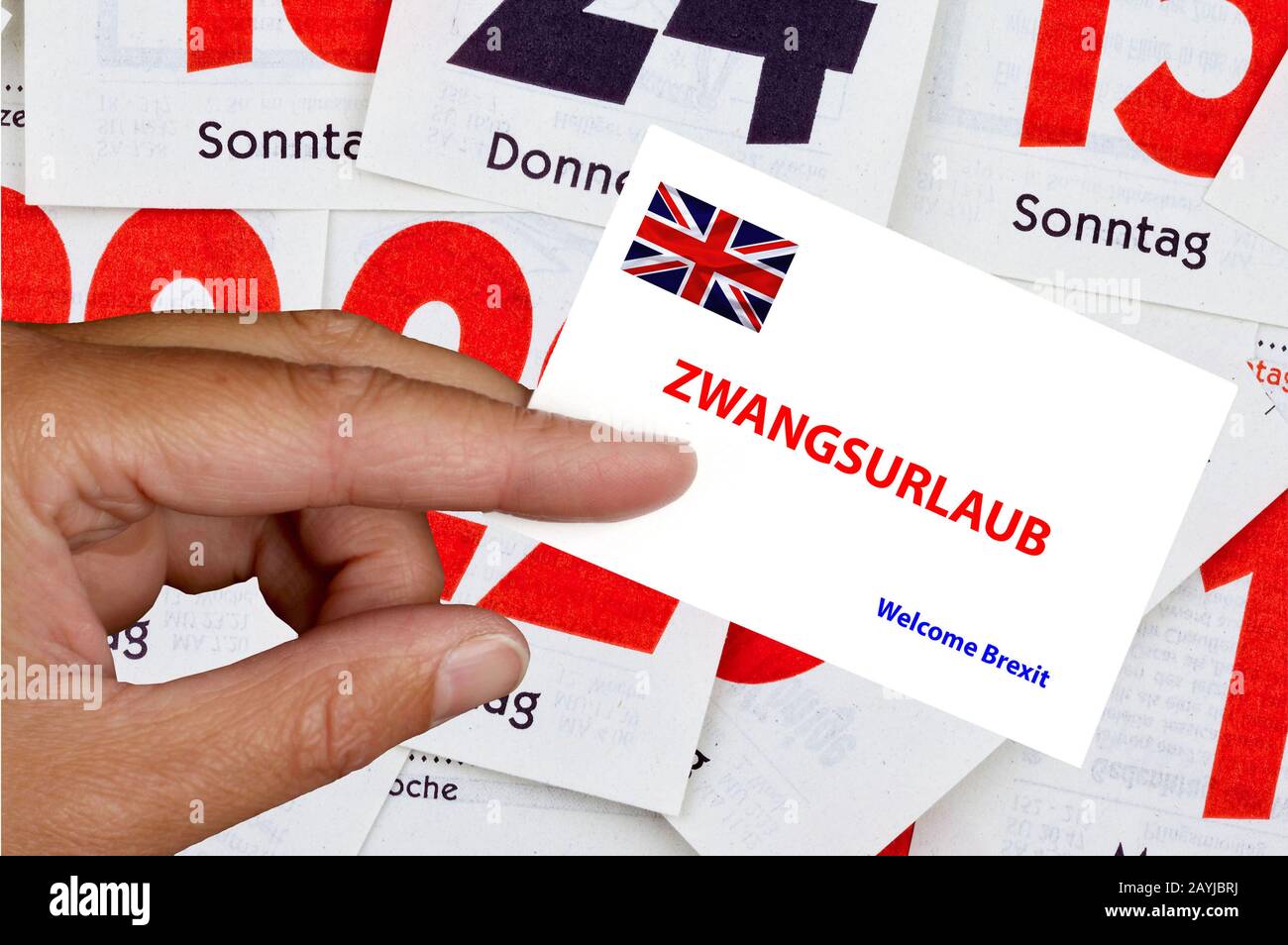 hand holding calling card with Union Jack lettering Zwangsurlaub, forced holiday, break of parliament, Welcome Brexit, composing, United Kingdom, England Stock Photo