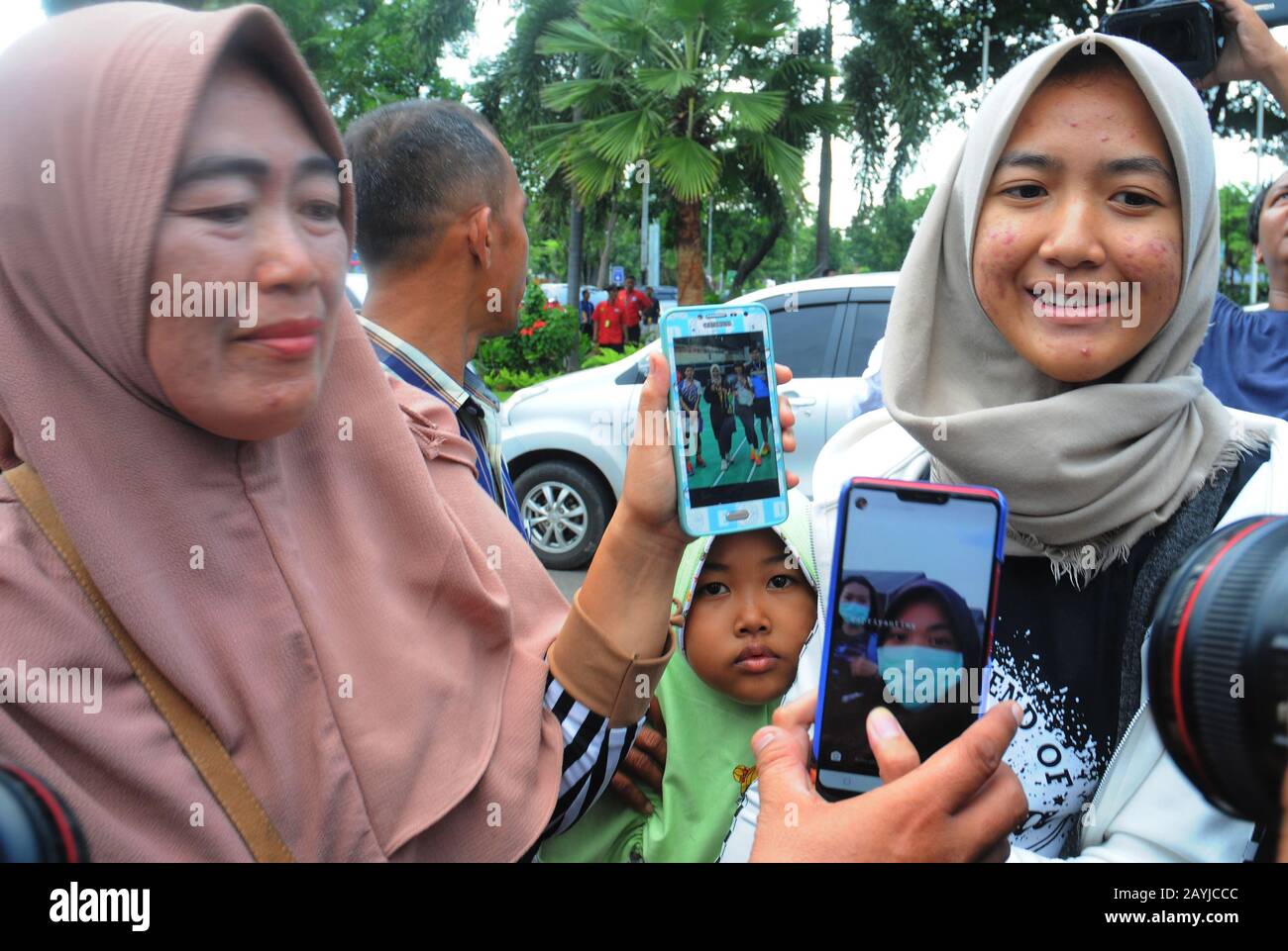 Jakarta, Indonesia. 15th Feb, 2020. Family shows photos of Indonesian citizens who have been observed in Natuna to be picked up and returned with their families at Halim Perdanakusuma Airport in Jakarta, Indonesia. About 250 Indonesian citizens were released after two quarantine period week at Natuna. The disease caused by a novel coronavirus (SARS-CoV-2) has been officially named COVID-19 by the World Health Organization (WHO). The outbreak, which originated in the city of Wuhan in China, has so far killed at least 1,526 people with more than 67,000 infected worldwide, mostly in China. (Cr Stock Photo