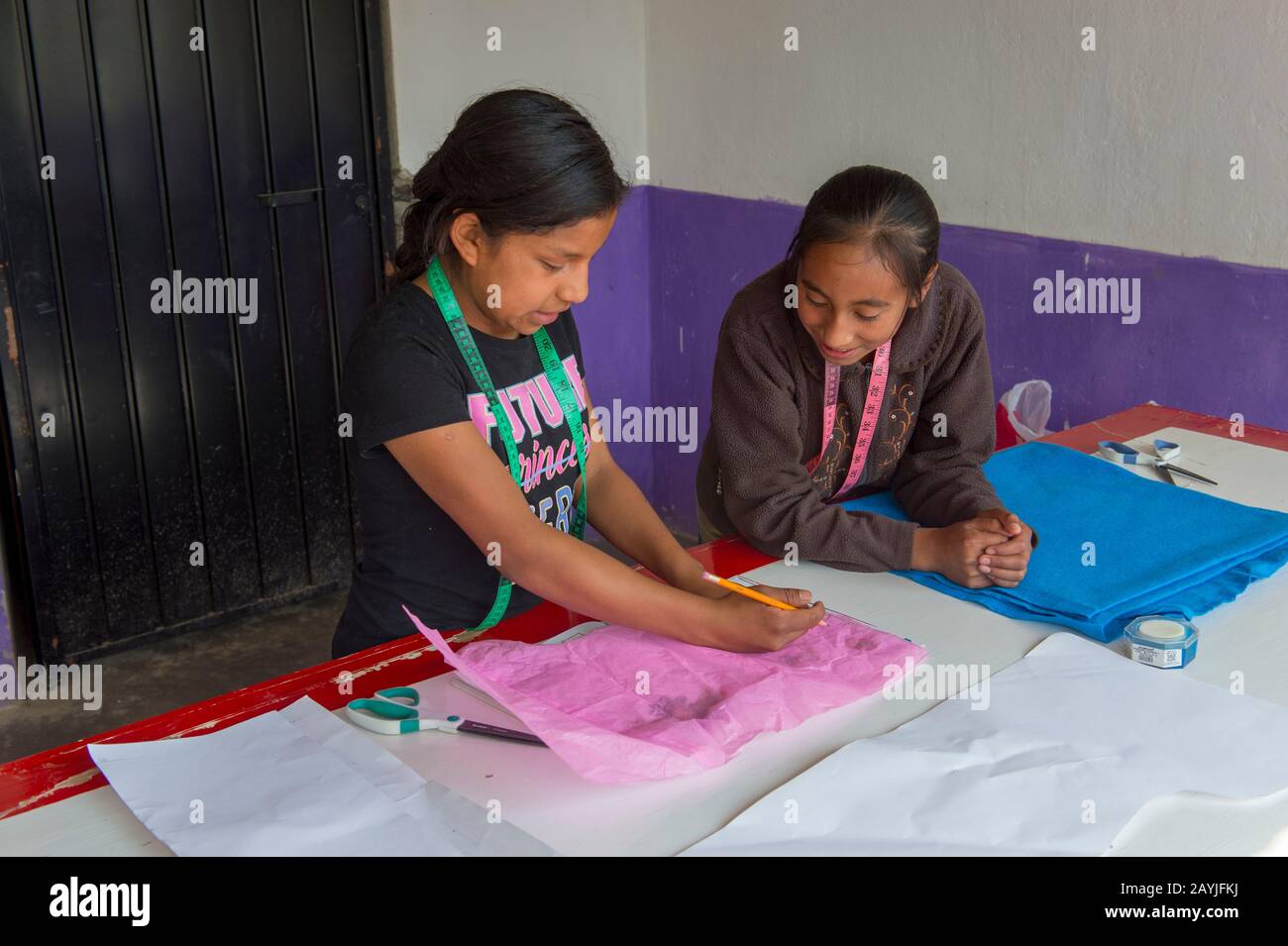 Mexican teenage girls in a sewing and how to establish a handicraft business workshop, which is taught by US women in the Mixtec village of San Juan C Stock Photo