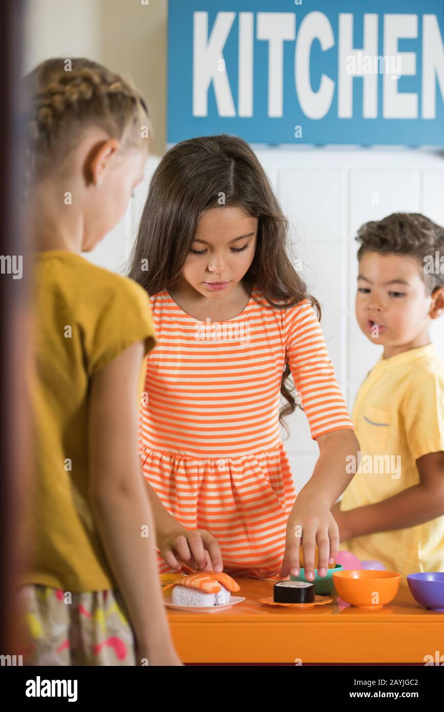 Kids playing in toy kitchen Stock Photo - Alamy
