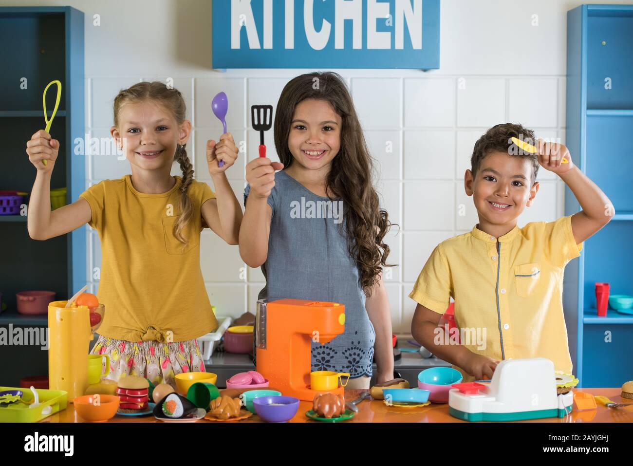 Happy smiling kids looking at camera at kids playroom Stock Photo - Alamy