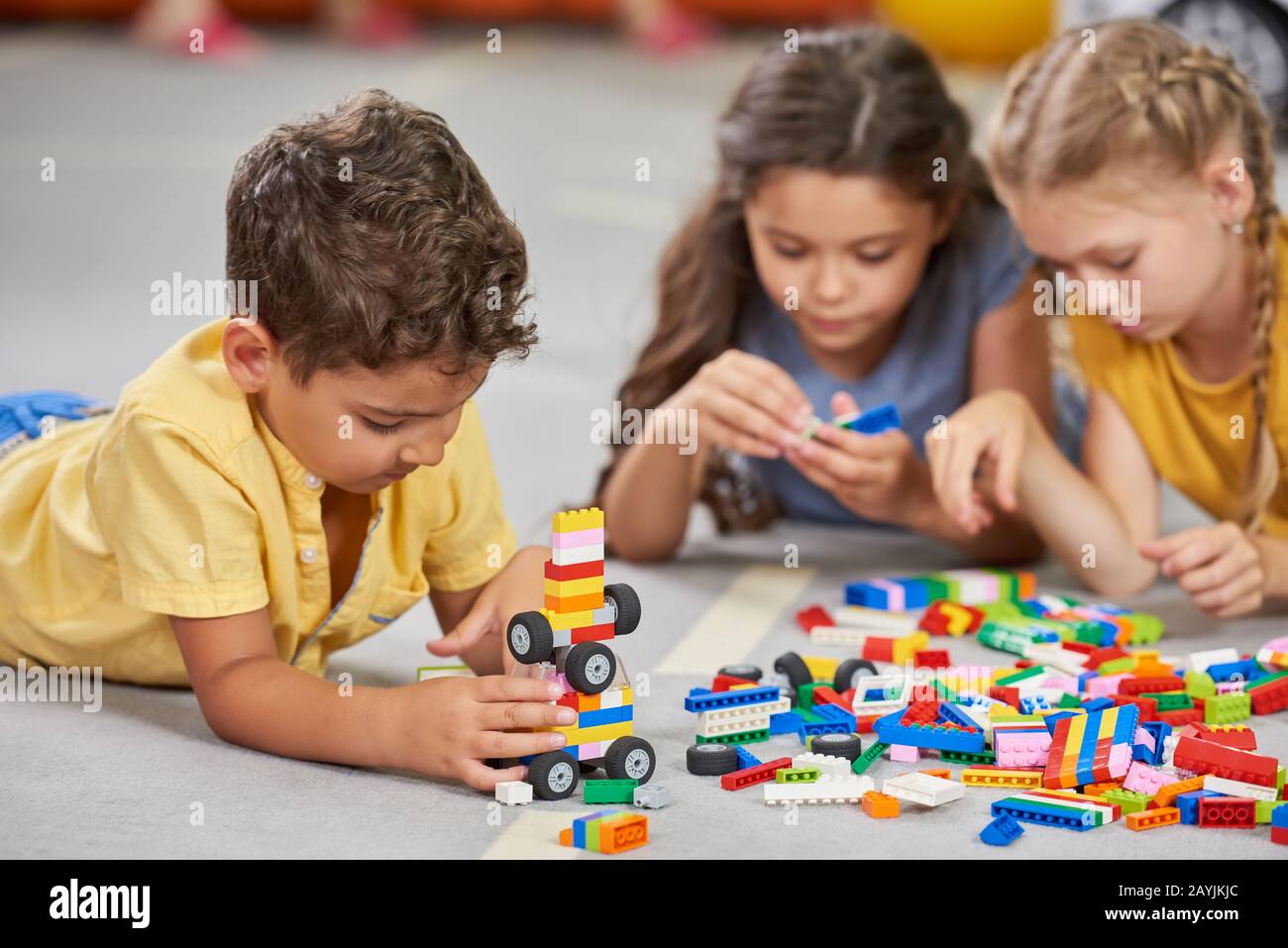 Children playing together in the classroom in kindergarten Stock Photo