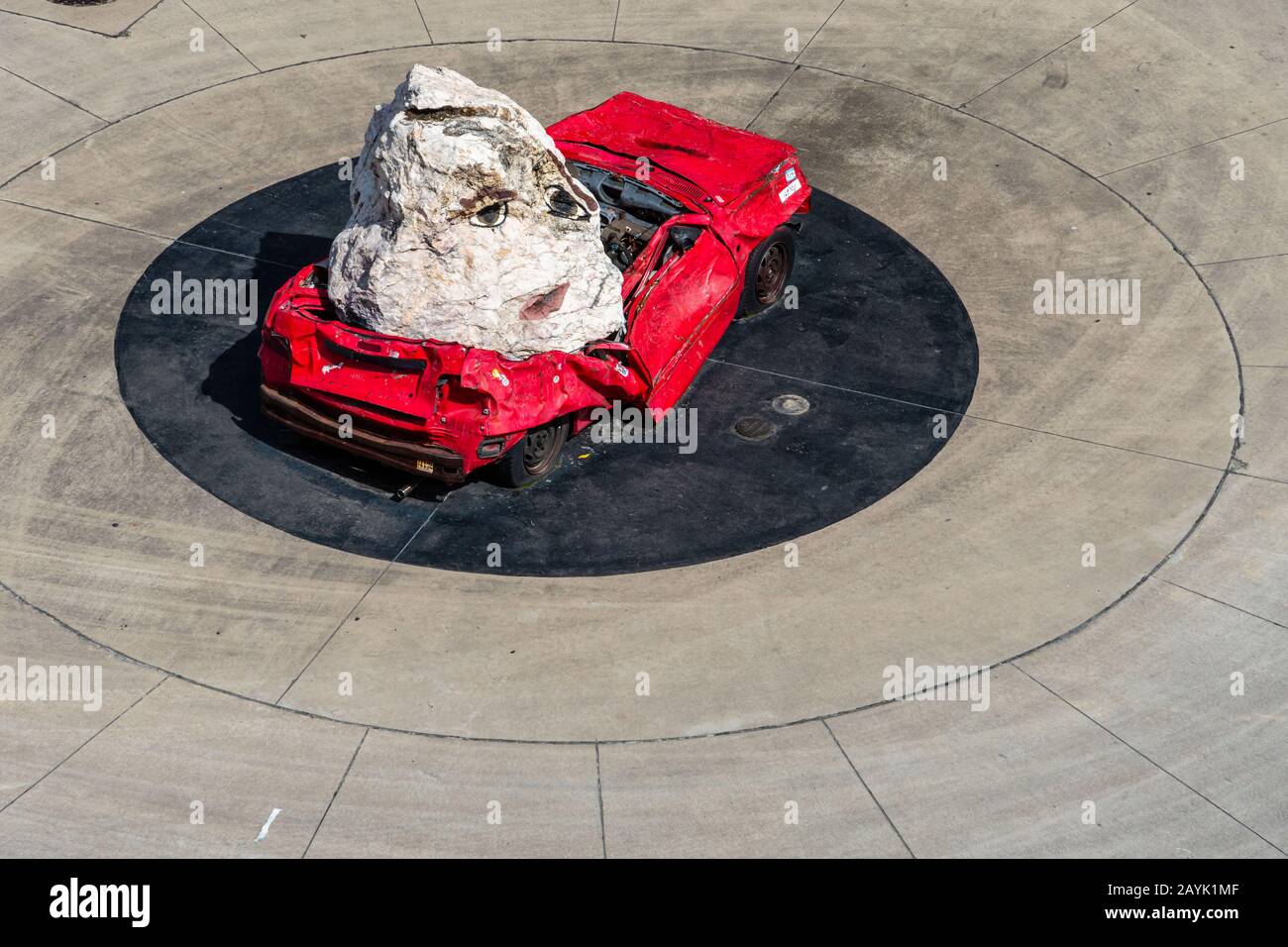 Sydney, NNSW 28 10 2018 Red car crushed by a huge rock with a face