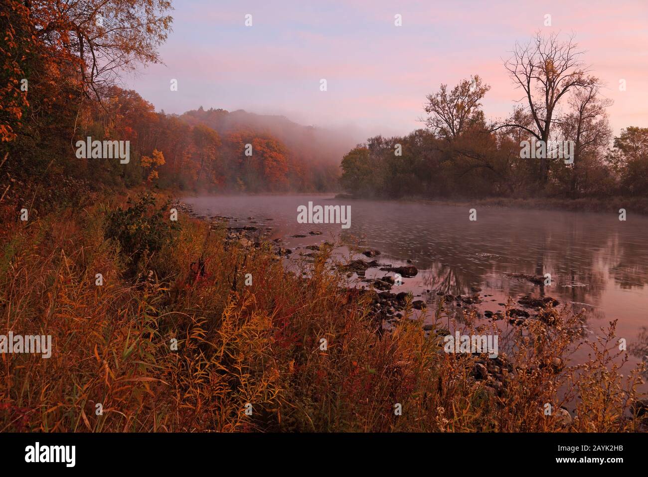The mist reflecting in the Grand River, shot at daybreak during Autumn, in Kitchener, Ontario, Canada. Stock Photo