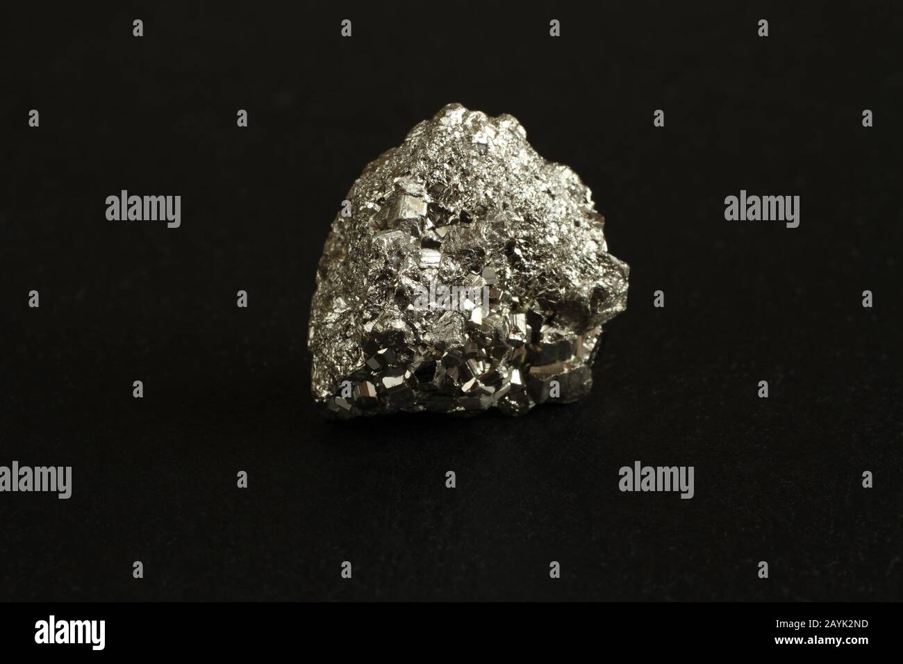 Mineral pyrite on the black stone plate Stock Photo