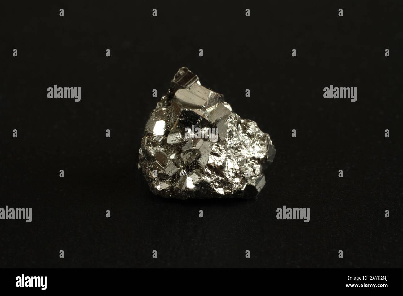 Mineral pyrite on the black stone plate Stock Photo