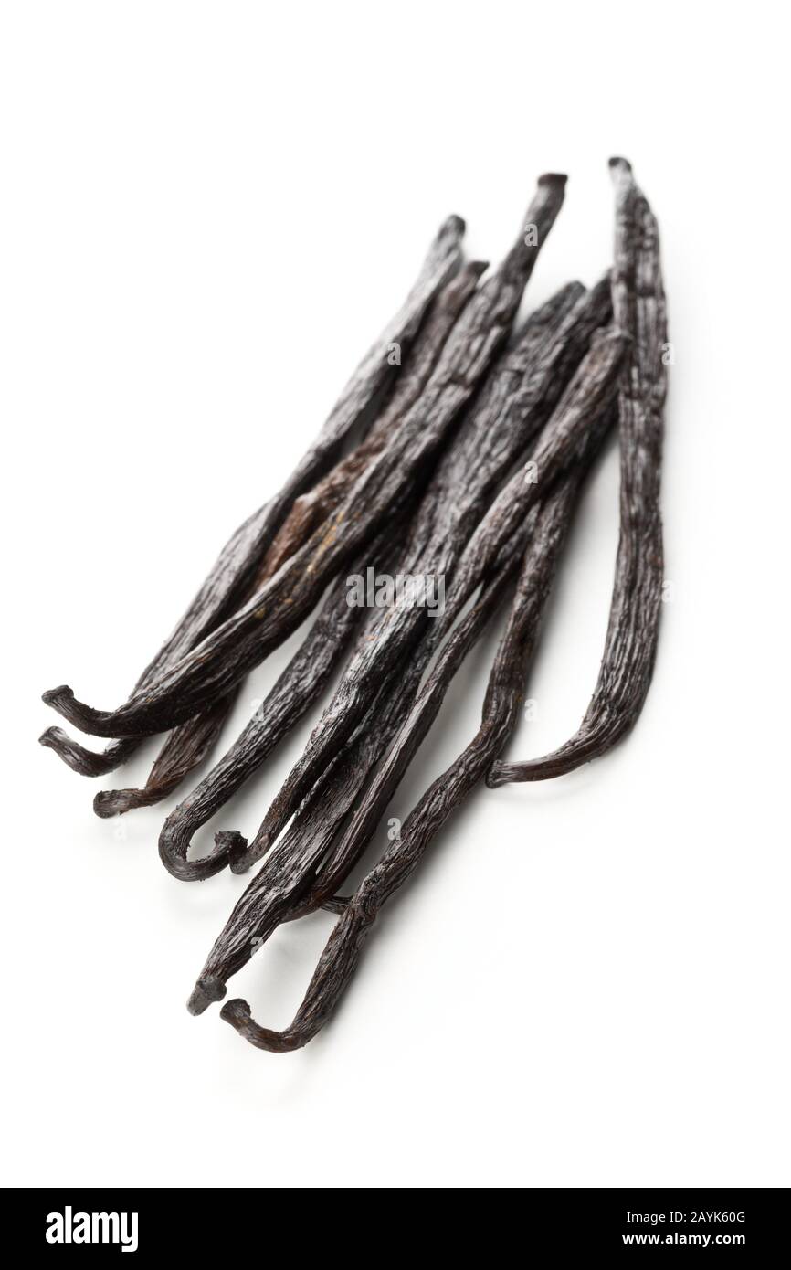 Bundle of dried bourbon vanilla beans or pods over white background - selective focus Stock Photo