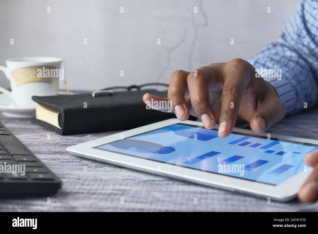 Close up of man hand analyzing chart on digital tablet Stock Photo - Alamy