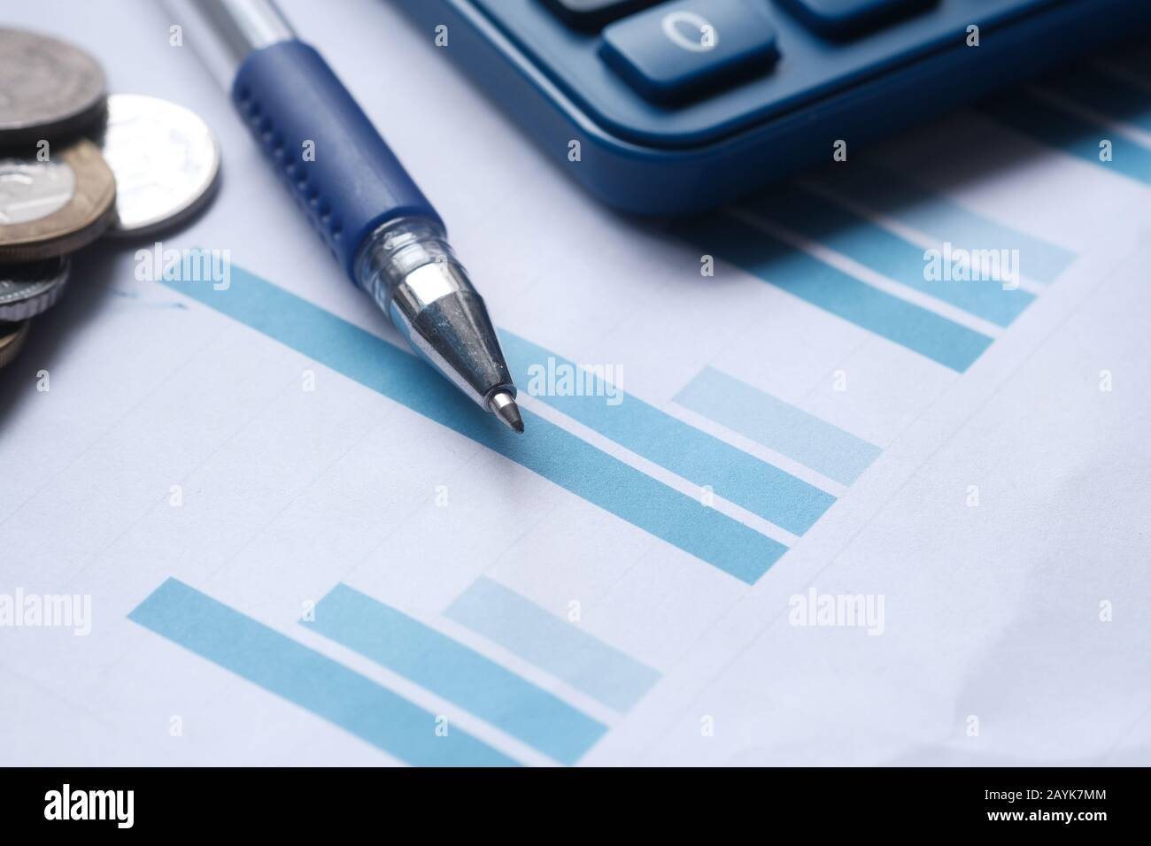 Close up of bar chart, coin and pen Stock Photo - Alamy