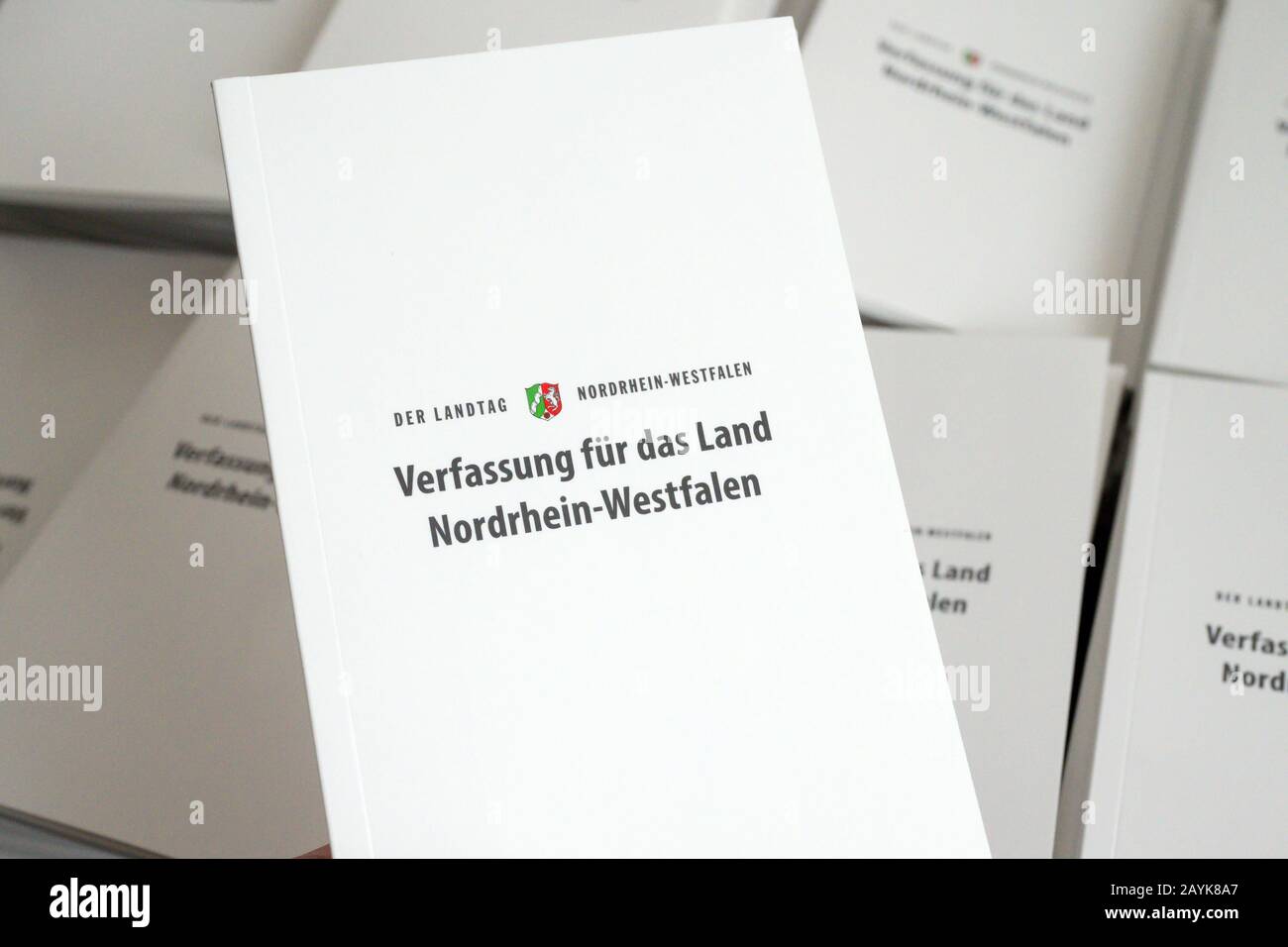 14 February 2020, North Rhine-Westphalia, Duesseldorf: A member of the state parliament holds a state constitution up to the camera. A pocket book with symbolic value: This year, the North Rhine-Westphalian state parliament will give all pupils who visit the parliament a compact edition of the state constitution. Around 35,000 young people visit the Landtag every year. According to a speaker of the state parliament, the occasion for the action is the 70th anniversary of the constitution. (to dpa: 'State parliament wants to distribute state constitutions to 35 000 pupils') Photo: Federico Gamba Stock Photo