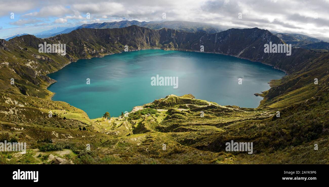 Panorama of the turquoise volcano crater lagoon of Quilotoa along the famous hike called Quilotoa Loop near Quito, Ecuador. Stock Photo