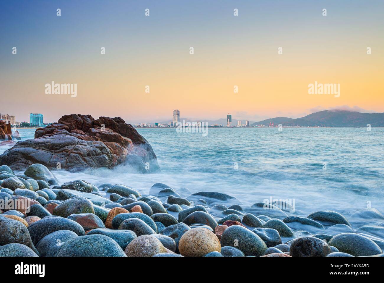 Quy Nhon city panorama from pebble beach and rock boulders in