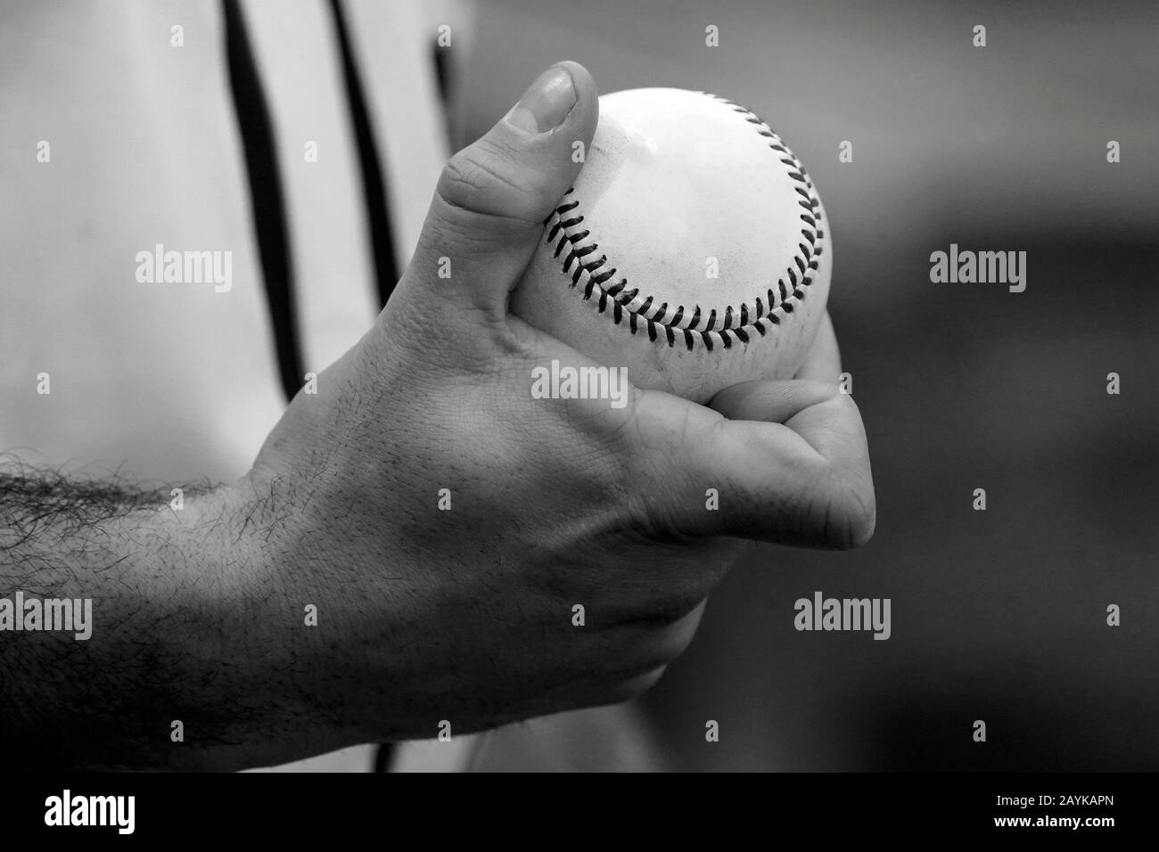 A pitcher shows how to grip a baseball Stock Photo Alamy