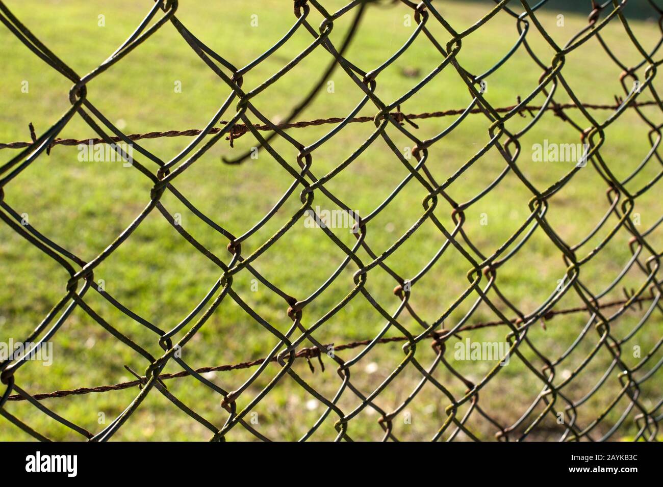 Wire fence (cyclone fencing) in repeating patterns (fence, chain, link) Stock Photo