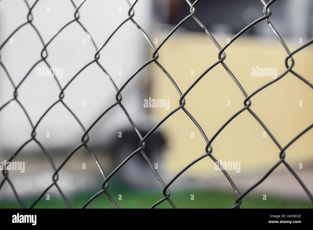 Wire fence (cyclone fencing) in repeating patterns (fence, chain, link) Stock Photo